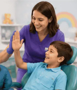 Pediatric dentist helping a child feel comfortable during a gentle preventive dental appointment.